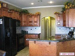 kitchen with maple cabinets, granite counters, canister lighting