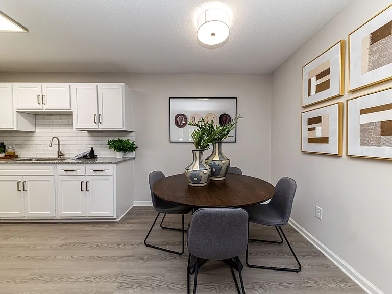Dining area with hardwood-style flooring and overhead lighting