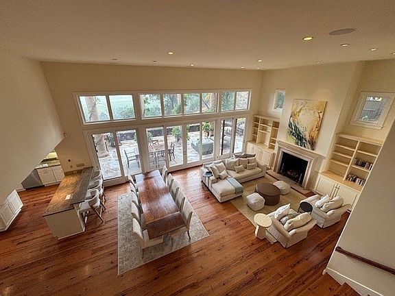 Open living room and dining room looking out to stone patio and views of Napa Valley.