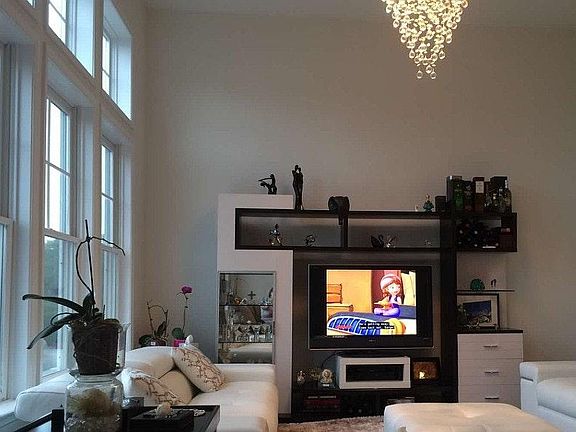 Amazing high ceiling living room with a lot of light
