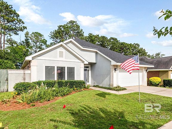 Ranch-style home featuring a garage and a front yard