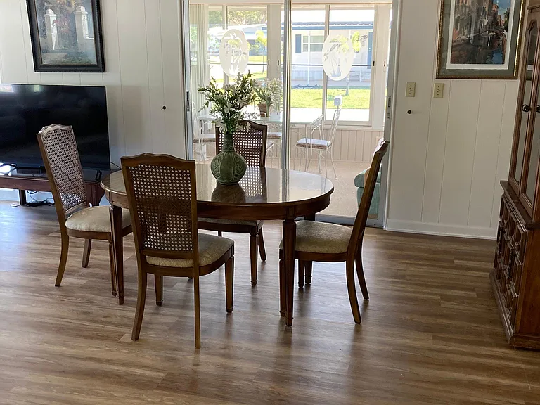 Dining room that usually looks out the sliding glass doors to the street through the Sun porch that got torn off in the last hurricane. The inside, by the way, has been fully restored. All new ceilings, roof, and some new wall board.