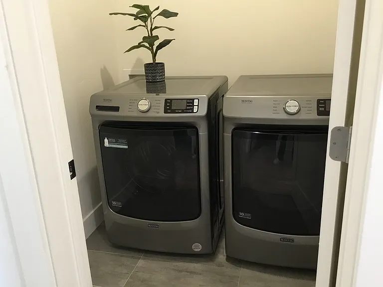 Dedicated washer and dryer room designed for added convenience.