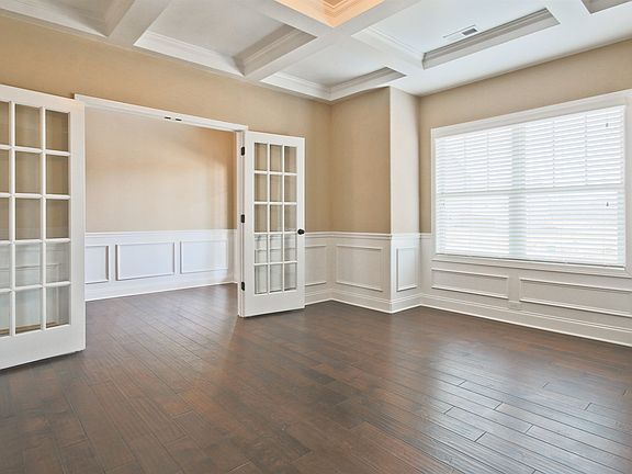 Glass Door Living Room with a Coffered Ceiling