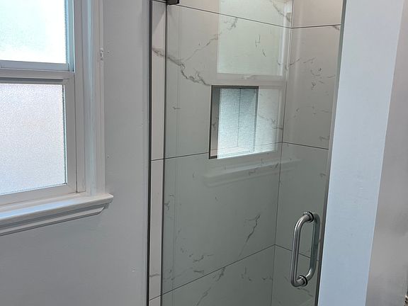 New porcelain tile shower and glass door