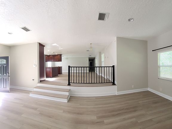 Panoramic view of Living Room into Kitchen & Dining area.
