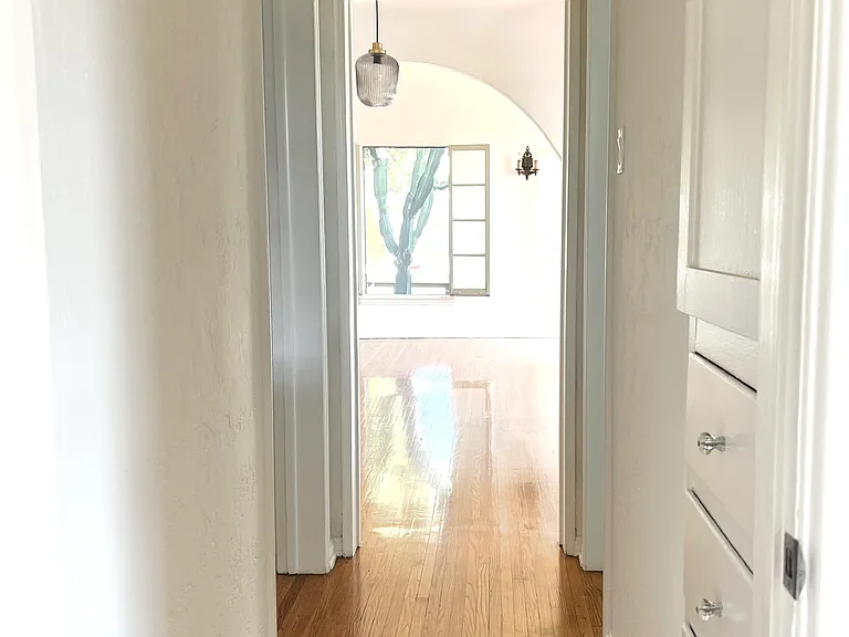 Hallway with original built in linen closet leading from bedroom to front rooms