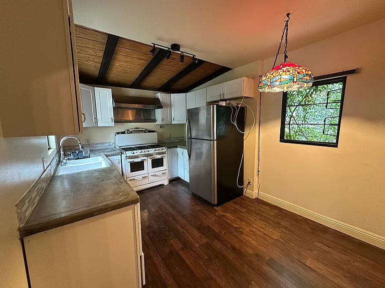 Kitchen with stainless steel appliances and six burner/double oven range