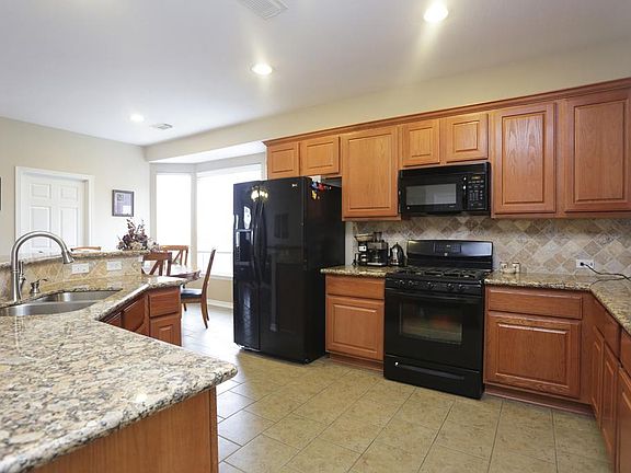 KITCHEN [13X12] This recently updated Kitchen showcases beautiful granite counters and a stone backsplash. The Gas range will bring out the gourmet cook in you. Ceramic tile floors extend into the adjacent Breakfast area.