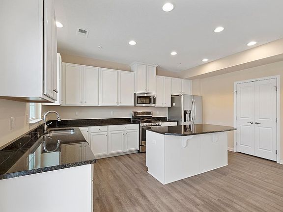 Gourmet Kitchen with upgraded cabinetry, granite counter top and stainless still appliances.
