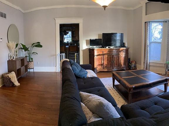 Family Room (16'x16') adjacent to the formal living room hardwood floors, crown molding, original wood work, bay window with built in, storage closet.