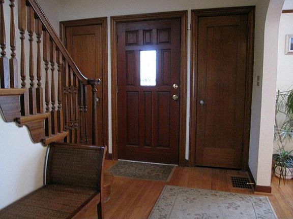 Elegant and gracious entry hall with period detailing & mahogany trim, woodwork and doors. Open staircase to 2nd level.