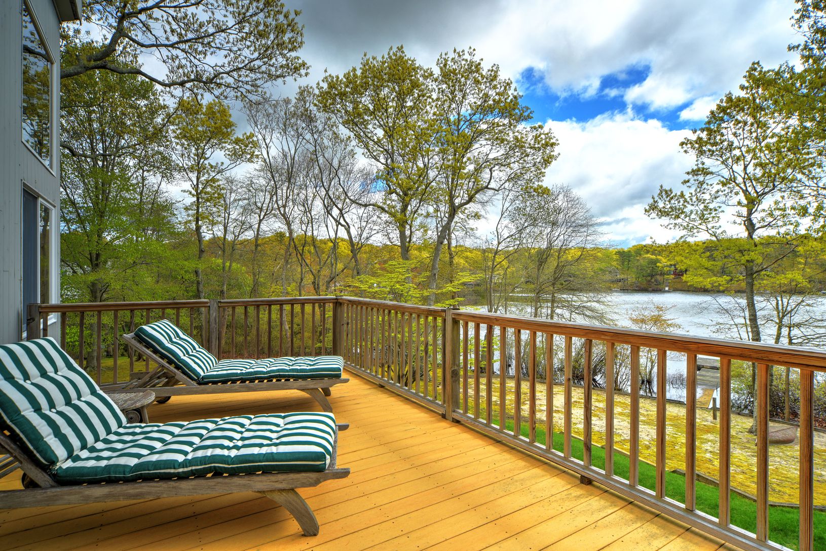  Tall Living Room Sliding Glass Opens to Spacious Deck for Lounging and Outside Dining