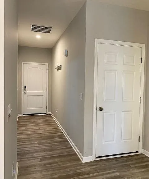 Solid wood front door, door to attached 2 car garage.
