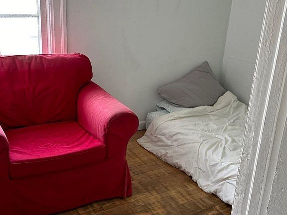 Unoccupied bedroom has a sizable nook to the right.