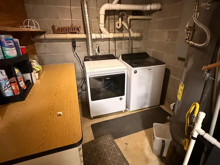 Dedicated laundry area with washer and dryer, plus a counter for folding and organizing household essentials.