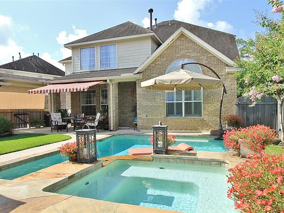 Here's the Back of the Home with the beautiful, Custom designed pool/spa.