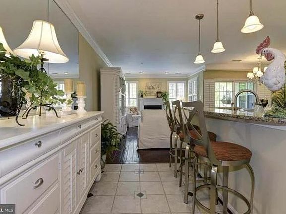 Entryway/foyer with coat closet and ceramic tiled flooring and floor to ceiling mirrors