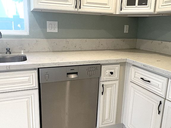 Large remodeled kitchen includes appliances