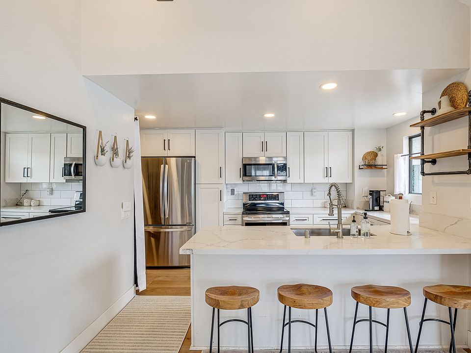 New kitchen with white shaker cabinets and ss appliances.