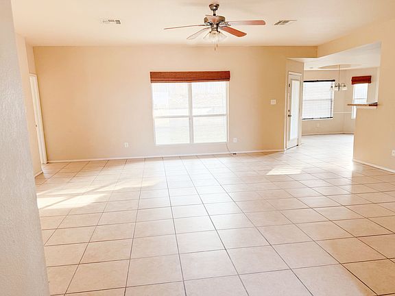 The large living room from the entry side with a great fan/light.