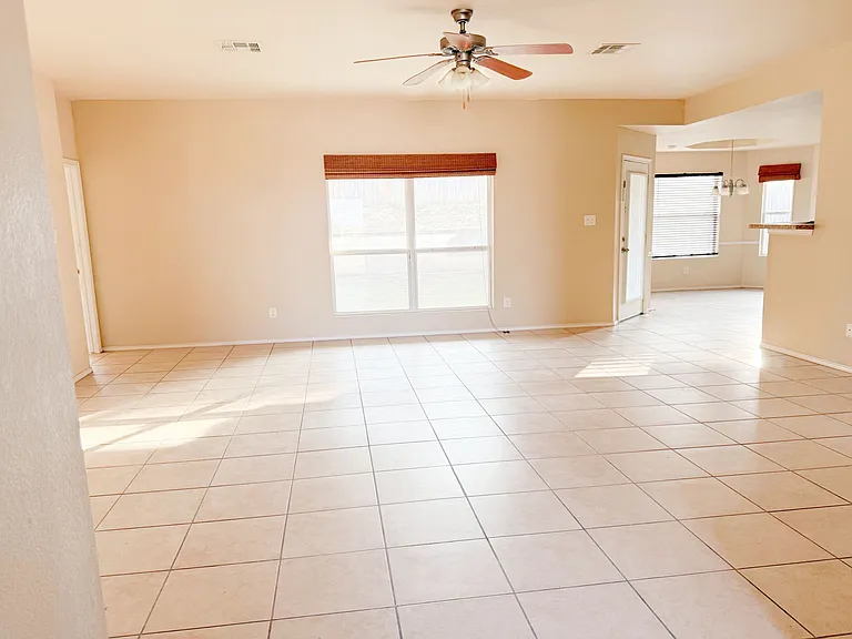 The large living room from the entry side with a great fan/light.