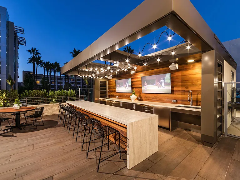 Upscale bar seating and TVs for open_air dining.