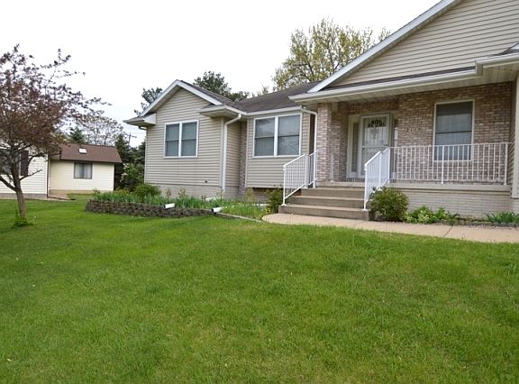 Front Porch- flowers and greenery line the sidewalk as you approach the front door. Full length glass storm door with intercom system to greet your guests.