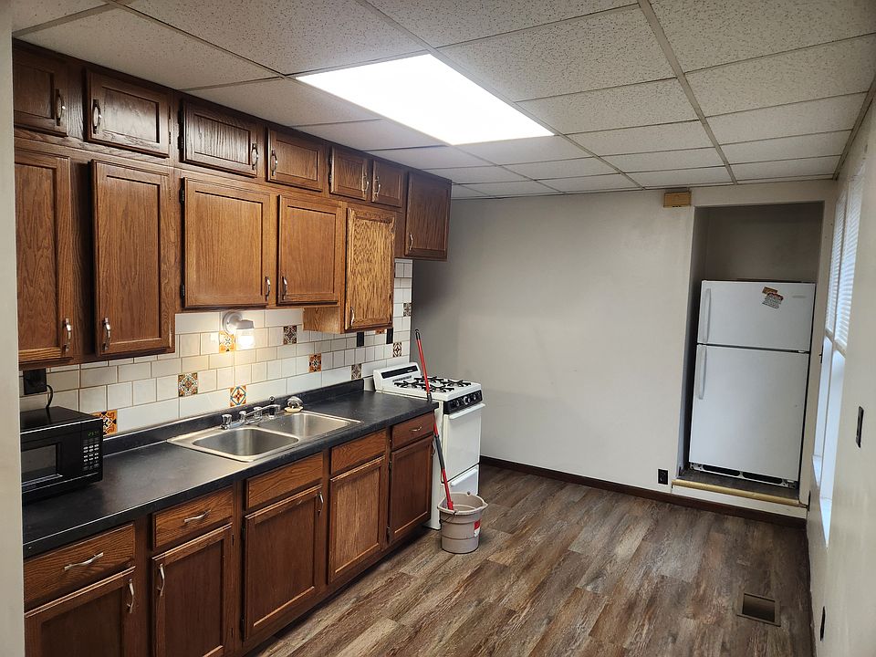 Kitchen with alcove refrigerator as seen from the living room