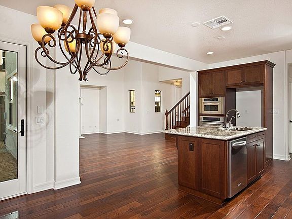Dining Area and Kitchen with an open Living Area and gorgeous hardwood floors.