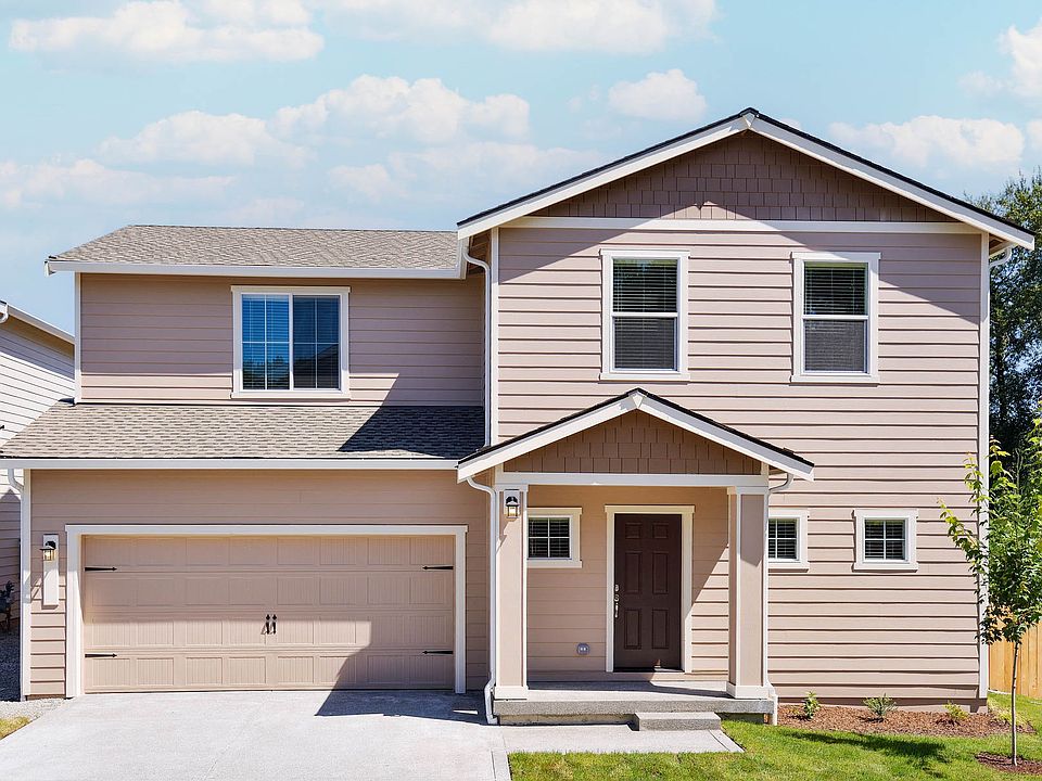 Beautiful two story home at Connell Park with siding and stone and front yard landscaping