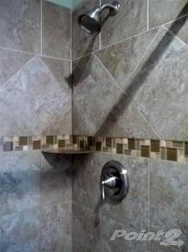 Glass tiled accents in shower.