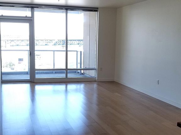 Spacious hardwood floor lounge room with balcony.