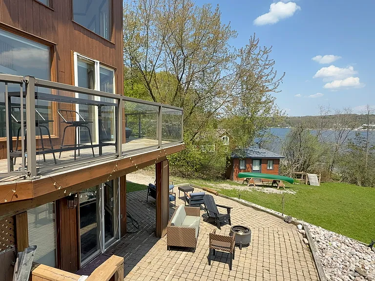 Lower deck with fire pit, outdoor shower and access to interior bar and entertainment area