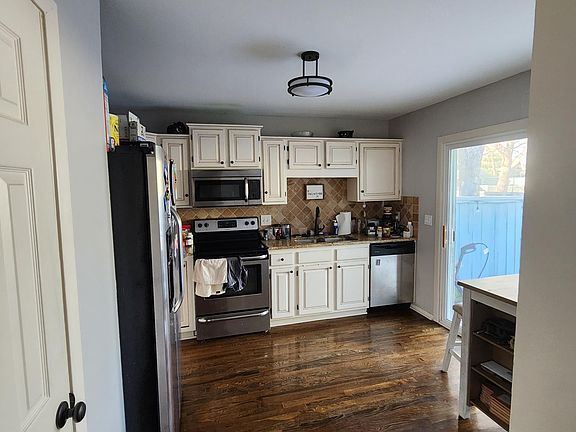 Kitchen space with sliding glass door to back patio.