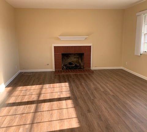 Front, bright living room with fireplace.