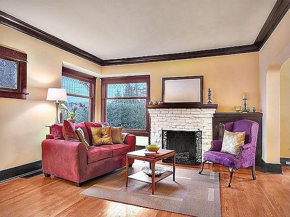 Spacious living room has oversized windows & high ceilings.