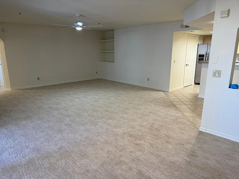 Super spacious family room with new ceiling fan and light. Built-in book shelves and new carpet.