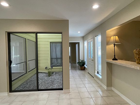 Another view of the indoor atrium and front door entry.