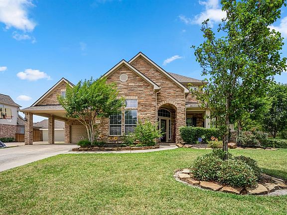 Wonderful stacked stone elevation & front wrap-around porch, great curb appeal with lush landscaping.