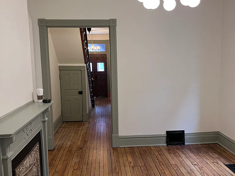 Dining room looking toward the front door and under-stairs closet
