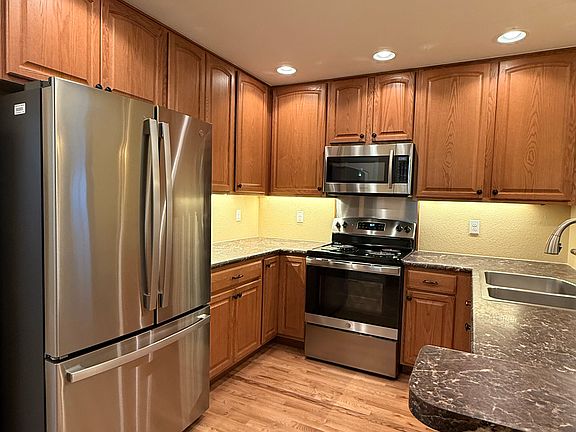 Kitchen with 42" cabinets, under cabinet lighting, new fridge.