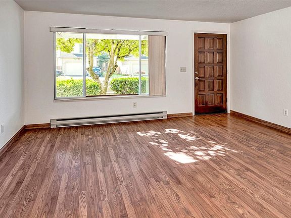Living room with big window of beautiful flower tree in front yard