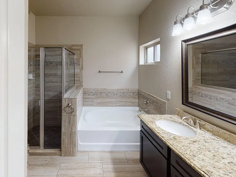 Elegant Primary Bathroom with Double Sink Vanity and Garden Tub