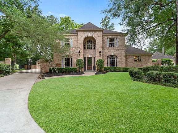 Front view with driveway and gate