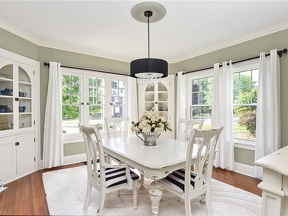 Formal Dining Room abounds hard wood flooring and corner cabinets. The chandelier adds a little bling!