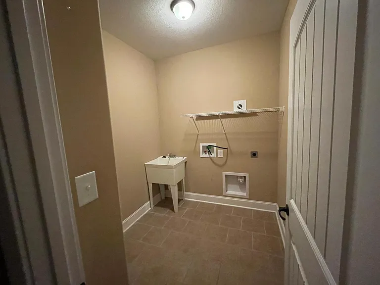 Spacious laundry room with utility sink.