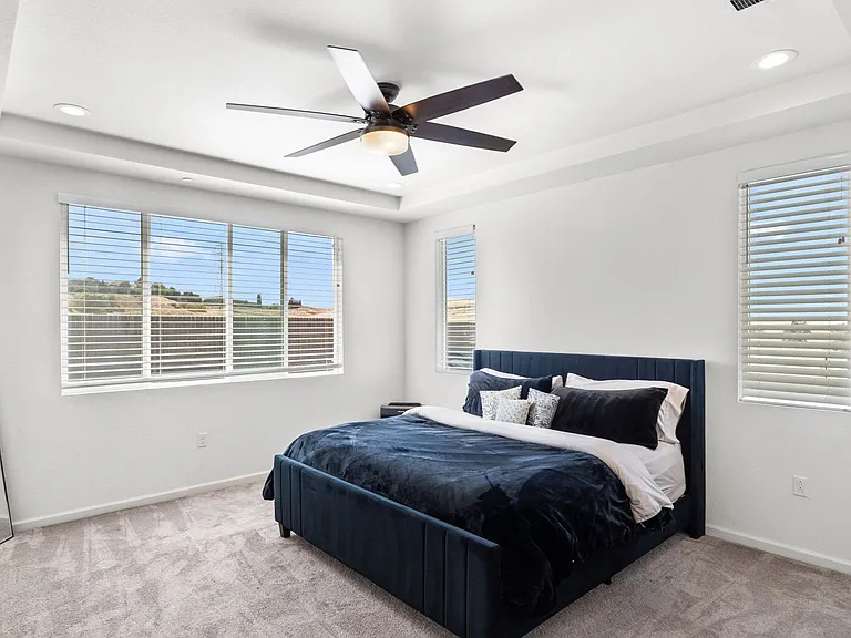 Upstairs, the oversized primary suite features hillside views and abundant natural light.