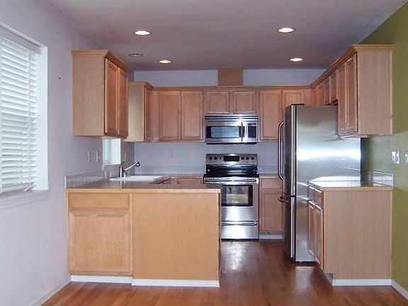 Modern and open kitchen with stainless steel appliances.