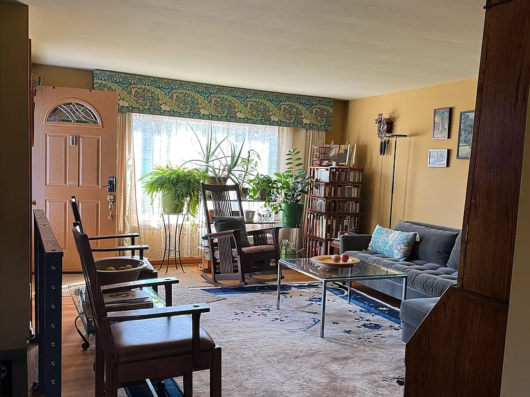 View of living room and front door from spacious kitchen opening